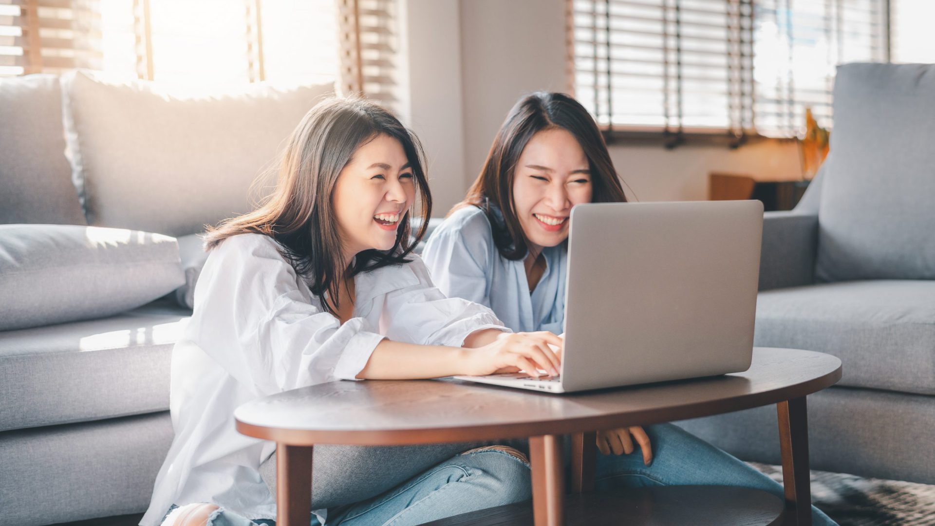 Two women checking a website together on a laptop